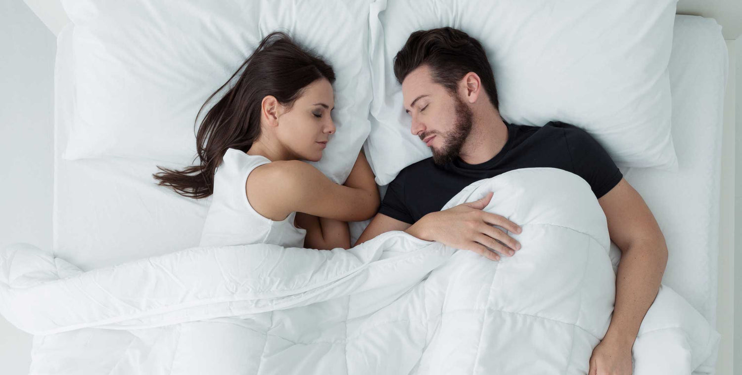 a couple sleeping in bed on their new agility mattress