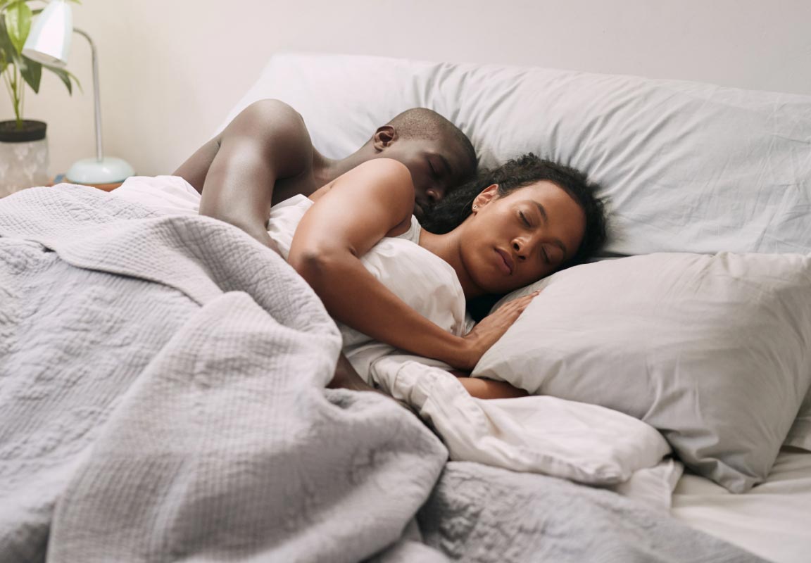 A couple sleeping in bed