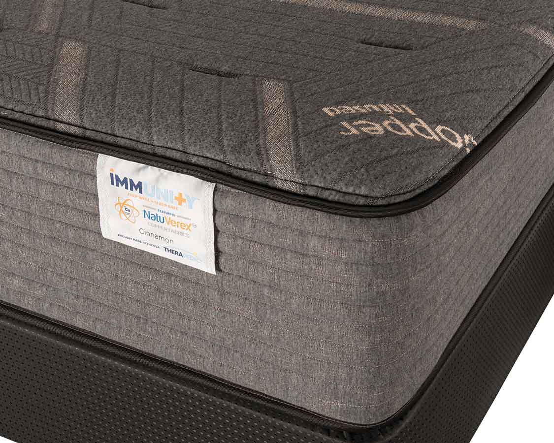 Detail shot of Immunity Cinnamon copper mattress on agility foundation at an angle with a white background.