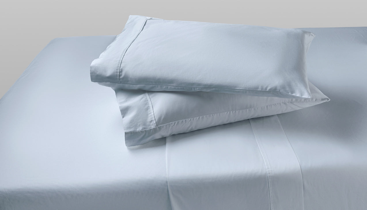 Sheet set with two pillows stacked on top of each other in Zen Blue
