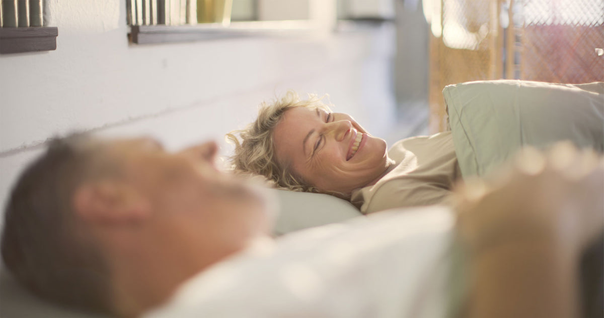 Mature Couple Sharing Peaceful Morning Moment In Sunlit Bedroom