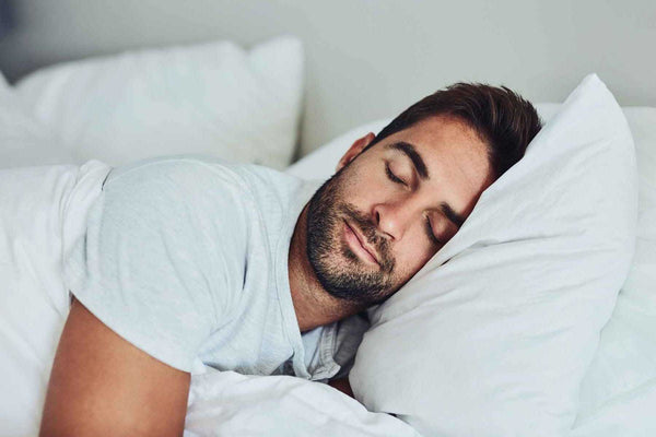 a man soundly sleeping on his new agility mattress