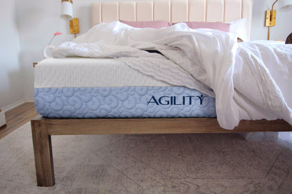 Agility mattress in a room setting on a wooden bed frame. 