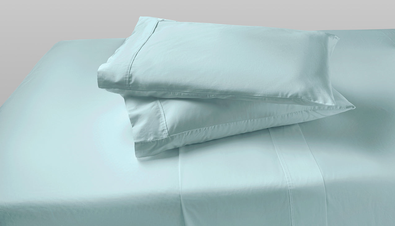 Sheet set with two pillows stacked on top of each other in Sterling Green color