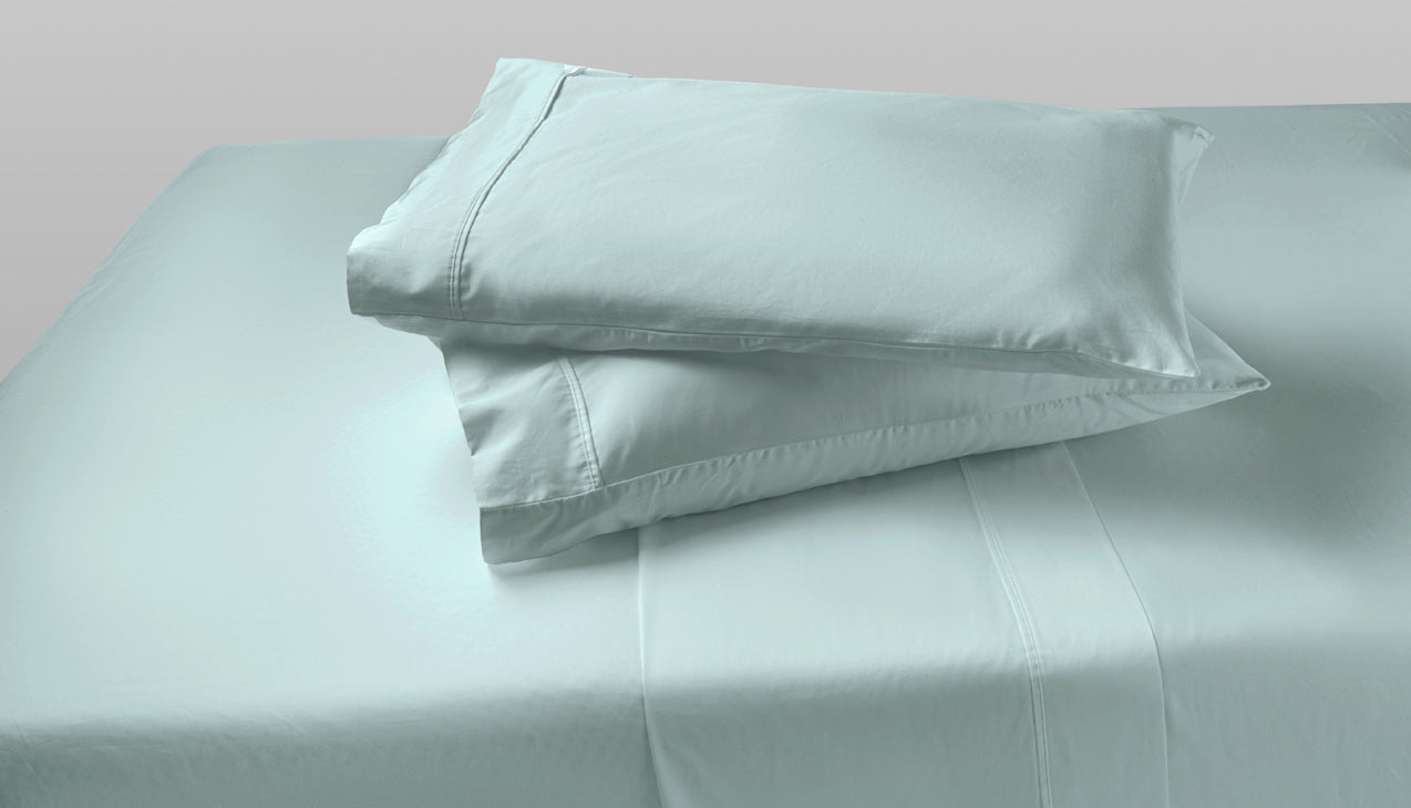 Two agility cool foam pillows stack on top of each other with Sterling Green pillow sheets